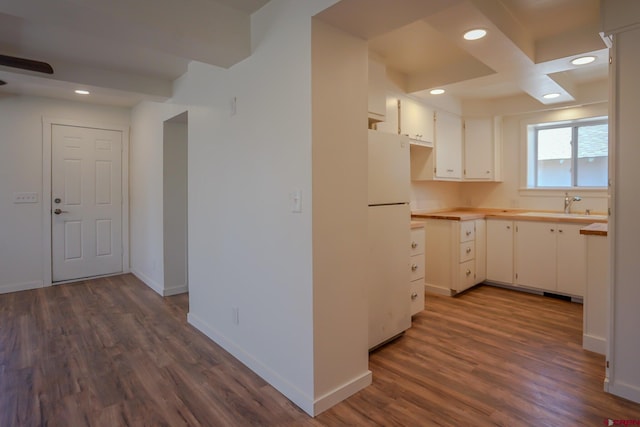 327/327.5 E 7th St, Walsenburg, CO 81089 - kitchen featuring freestanding refrigerator, a sink, dark wood-type flooring, white cabinetry, and recessed lighting
