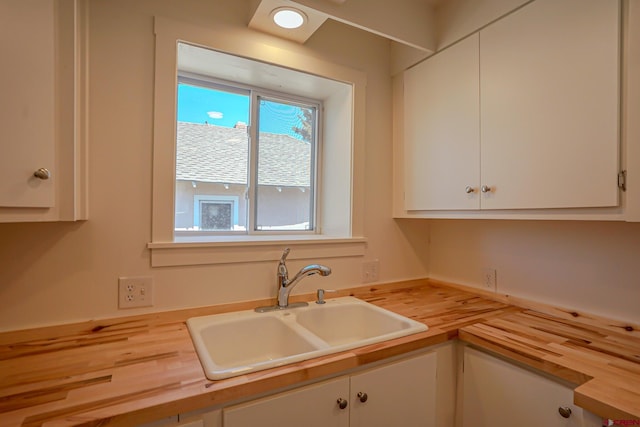 327/327.5 E 7th St, Walsenburg, CO 81089 - kitchen featuring wooden counters, a sink, and white cabinetry