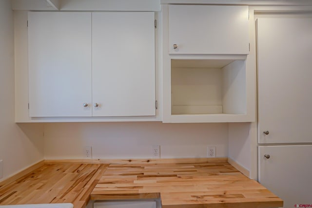 327/327.5 E 7th St, Walsenburg, CO 81089 - kitchen featuring white cabinetry, wood finished floors, and baseboards
