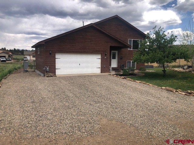 22 Lancer Ct, Pagosa Springs, CO 81147 - view of front of house featuring gravel driveway and an attached garage