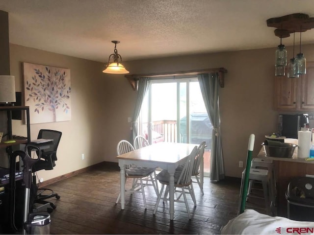 22 Lancer Ct, Pagosa Springs, CO 81147 - dining area with dark wood-style floors, baseboards, and a textured ceiling