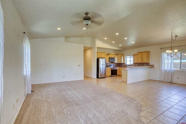 2038 Park Ave, Pagosa Springs, CO 81147 - kitchen featuring appliances with stainless steel finishes, open floor plan, a chandelier, ceiling fan, and plenty of natural light