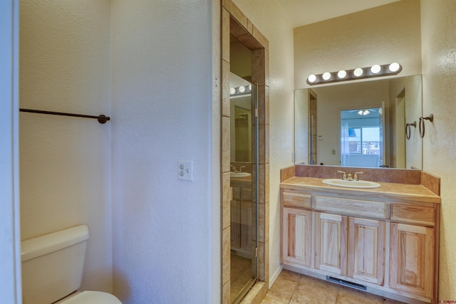 2038 Park Ave, Pagosa Springs, CO 81147 - bathroom with a textured wall, toilet, vanity, and tile patterned floors