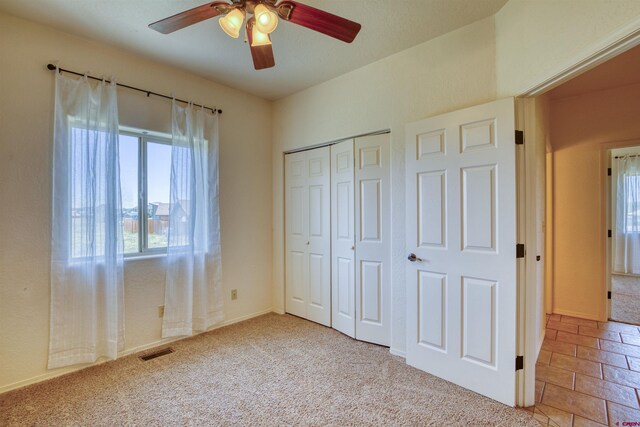 2038 Park Ave, Pagosa Springs, CO 81147 - unfurnished bedroom with a closet, carpet floors, and a ceiling fan