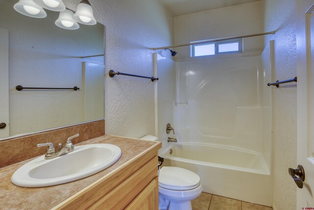 2038 Park Ave, Pagosa Springs, CO 81147 - bathroom with a textured wall, vanity, shower / washtub combination, toilet, and tile patterned floors