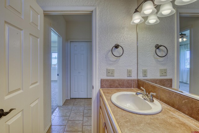 2038 Park Ave, Pagosa Springs, CO 81147 - bathroom featuring a textured wall, vanity, and a chandelier
