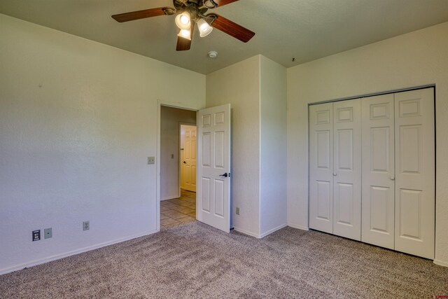 2038 Park Ave, Pagosa Springs, CO 81147 - unfurnished bedroom with carpet flooring, ceiling fan, baseboards, and a closet
