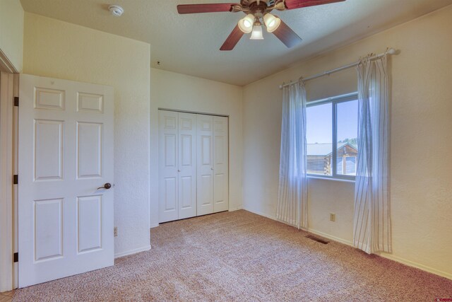 2038 Park Ave, Pagosa Springs, CO 81147 - unfurnished bedroom featuring carpet flooring, a closet, ceiling fan, and baseboards
