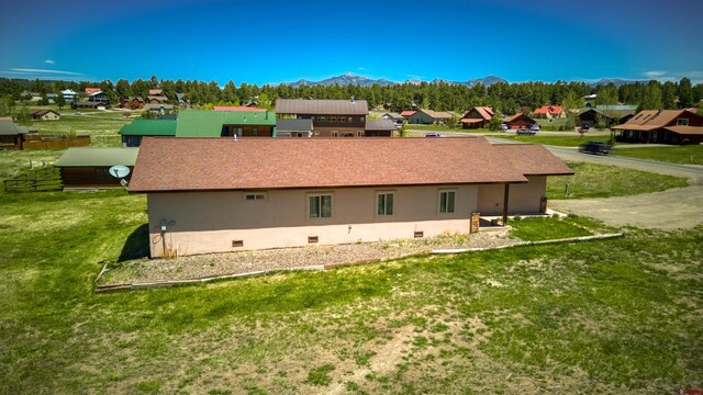 2038 Park Ave, Pagosa Springs, CO 81147 - view of side of property featuring a mountain view, a yard, a residential view, and stucco siding