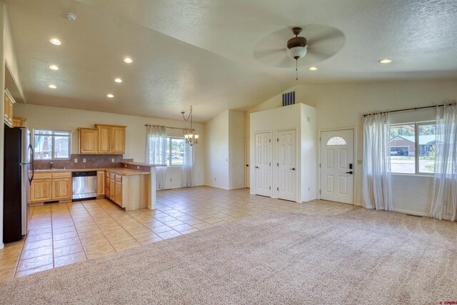 2038 Park Ave, Pagosa Springs, CO 81147 - kitchen with appliances with stainless steel finishes, light brown cabinetry, a chandelier, light colored carpet, and recessed lighting