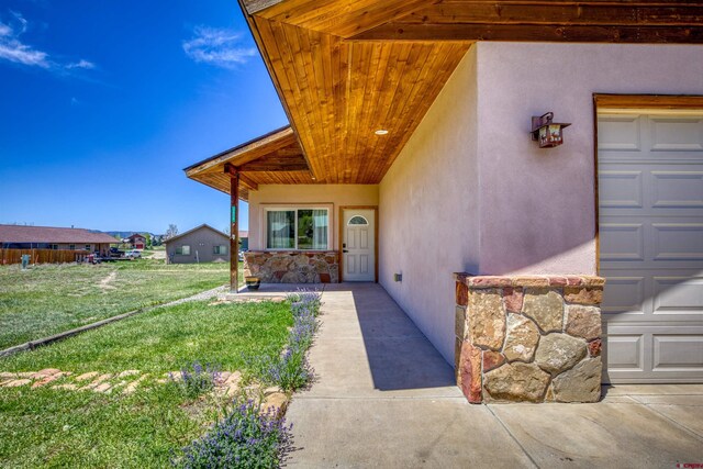 2038 Park Ave, Pagosa Springs, CO 81147 - property entrance featuring stucco siding and a lawn