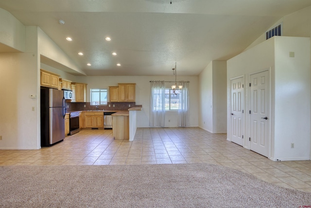 2038 Park Ave, Pagosa Springs, CO 81147 - kitchen featuring stainless steel appliances, light brown cabinets, vaulted ceiling, recessed lighting, and light tile patterned floors