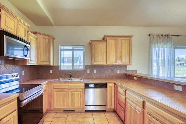 2038 Park Ave, Pagosa Springs, CO 81147 - kitchen with stainless steel appliances, a sink, light brown cabinets, and light tile patterned floors