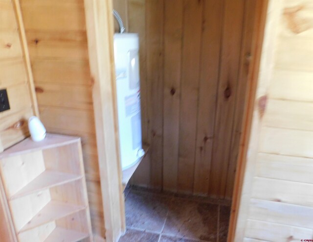 11787 Castle Rock Rd, Del Norte, CO 81132 - interior space featuring water heater and wood walls