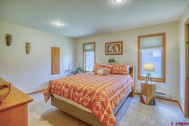 165 Twin Creek Cir, Pagosa Springs, CO 81147 - bedroom with a baseboard heating unit, light carpet, baseboards, and recessed lighting