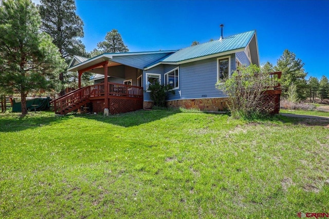 165 Twin Creek Cir, Pagosa Springs, CO 81147 - back of property with a yard, metal roof, a deck, and stairs