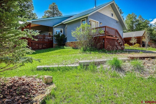 165 Twin Creek Cir, Pagosa Springs, CO 81147 - view of home's exterior with a deck, a lawn, and stairs