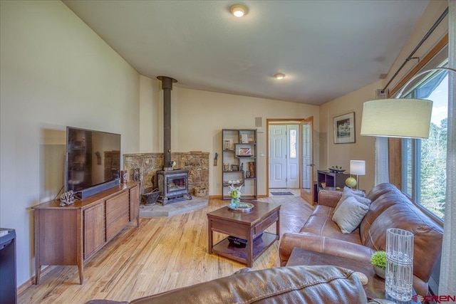 165 Twin Creek Cir, Pagosa Springs, CO 81147 - living room with vaulted ceiling, a wood stove, healthy amount of natural light, and light wood-style floors