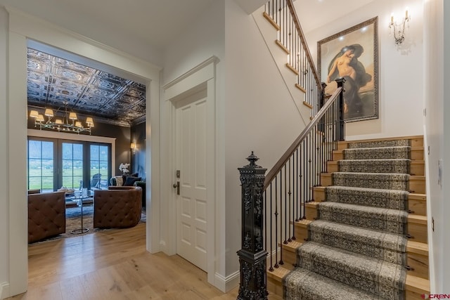 905 County Road 317, Crested Butte, CO 81224 - staircase with wood finished floors, a chandelier, and an ornate ceiling
