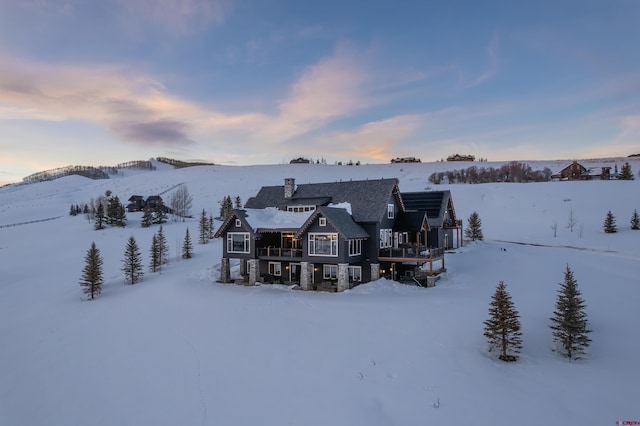 905 County Road 317, Crested Butte, CO 81224 - snow covered property featuring a balcony and a chimney