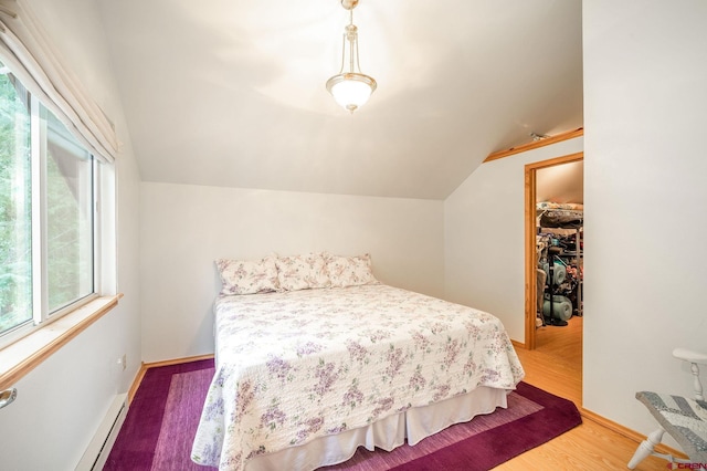 37 Verde Ln, Durango, CO 81301 - bedroom with lofted ceiling, baseboard heating, wood finished floors, and baseboards