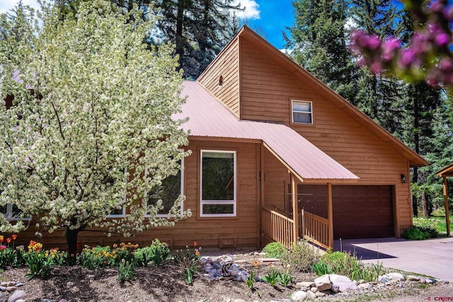 37 Verde Ln, Durango, CO 81301 - view of front facade featuring a garage, concrete driveway, and metal roof