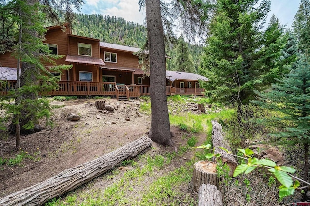 37 Verde Ln, Durango, CO 81301 - back of house featuring a wooded view, a wooden deck, and metal roof