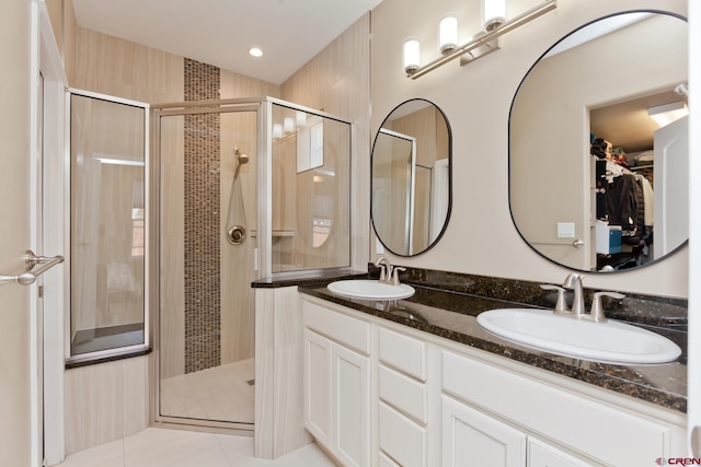 2488 Josefine Ln, Grand Junction, CO 81505 - full bathroom featuring a shower stall, double vanity, a walk in closet, tile patterned floors, and recessed lighting
