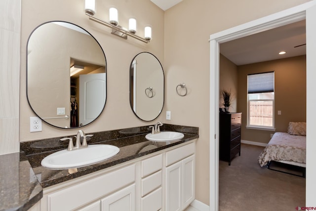 2488 Josefine Ln, Grand Junction, CO 81505 - ensuite bathroom featuring double vanity and baseboards