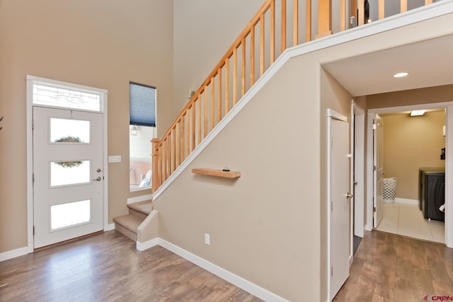 2488 Josefine Ln, Grand Junction, CO 81505 - foyer entrance featuring a high ceiling, stairway, wood finished floors, and baseboards