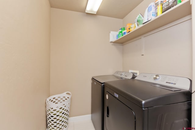 2488 Josefine Ln, Grand Junction, CO 81505 - laundry room featuring washing machine and dryer, baseboards, and light tile patterned floors
