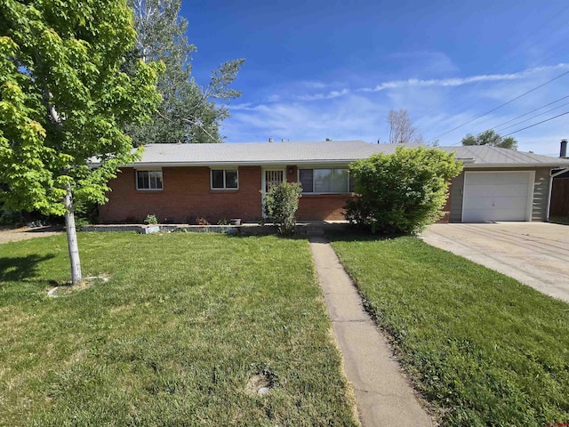608 Alameda Dr, Cortez, CO 81321 - single story home with brick siding, concrete driveway, a front lawn, and an attached garage