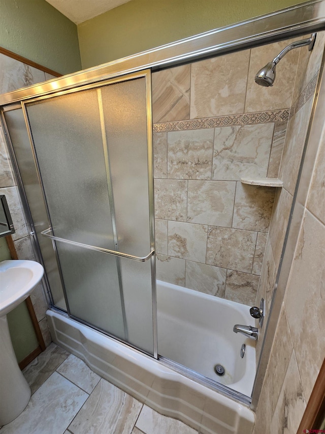 608 Alameda Dr, Cortez, CO 81321 - full bathroom featuring shower / bath combination with glass door and a textured wall