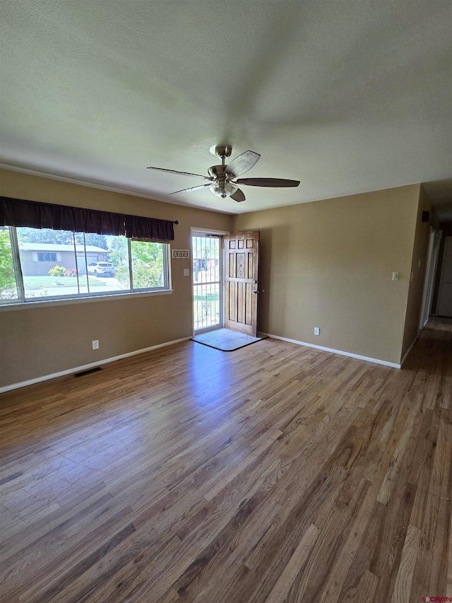 608 Alameda Dr, Cortez, CO 81321 - spare room featuring wood finished floors, a ceiling fan, and baseboards