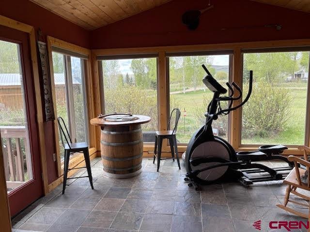 250 Pashuta Dr, Gunnison, CO 81230 - sunroom featuring vaulted ceiling, stone tile floors, and wood ceiling