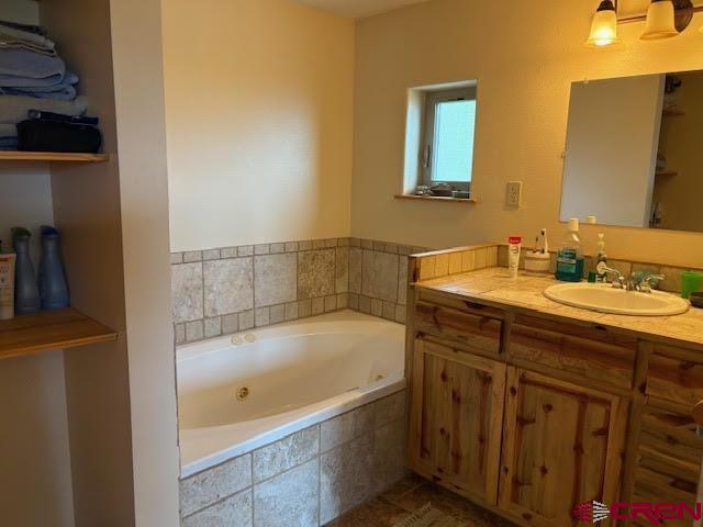 250 Pashuta Dr, Gunnison, CO 81230 - full bathroom with a jetted tub and vanity
