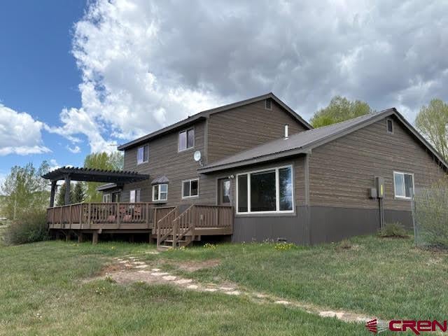 250 Pashuta Dr, Gunnison, CO 81230 - rear view of house featuring a pergola, a wooden deck, and a yard