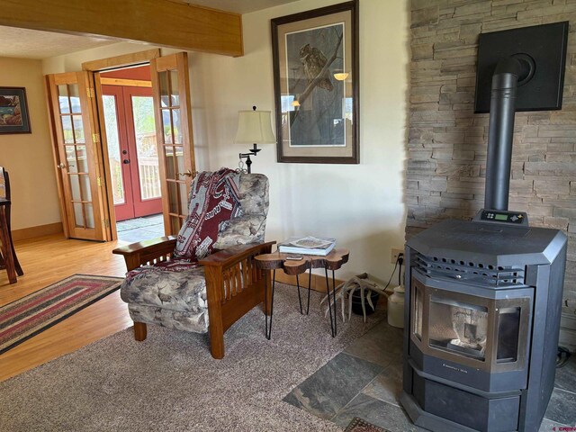 250 Pashuta Dr, Gunnison, CO 81230 - sitting room featuring a wood stove, french doors, baseboards, and wood finished floors