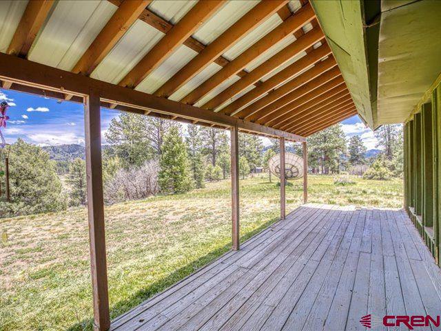 157 S Primrose Ridge Pl, Pagosa Springs, CO 81147 - wooden terrace featuring a lawn and view of scattered trees