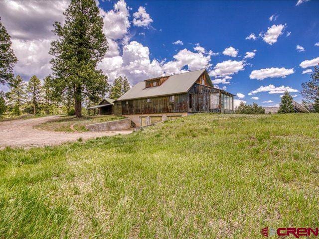 157 S Primrose Ridge Pl, Pagosa Springs, CO 81147 - view of front of home with a front lawn and a barn