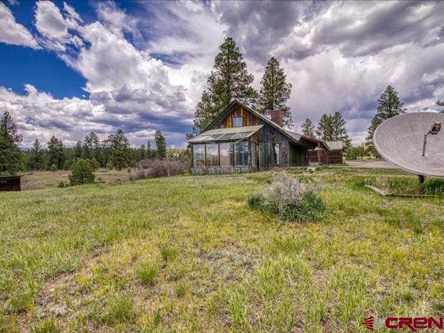 157 S Primrose Ridge Pl, Pagosa Springs, CO 81147 - view of grassy yard featuring an exterior structure and an outbuilding