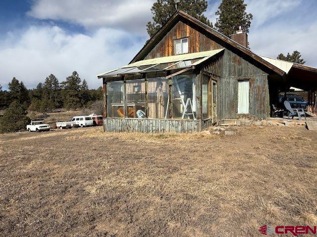 157 S Primrose Ridge Pl, Pagosa Springs, CO 81147 - rear view of property featuring a chimney