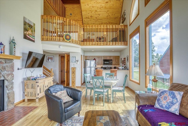 88 W Peregrine Cir Unit 4Unit 1, Pagosa Springs, CO 81147 - living room with a towering ceiling, light wood-type flooring, a fireplace, and baseboards