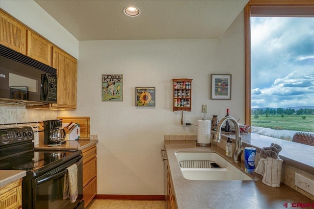 88 W Peregrine Cir Unit 4Unit 1, Pagosa Springs, CO 81147 - kitchen featuring black appliances, a sink, brown cabinetry, baseboards, and recessed lighting