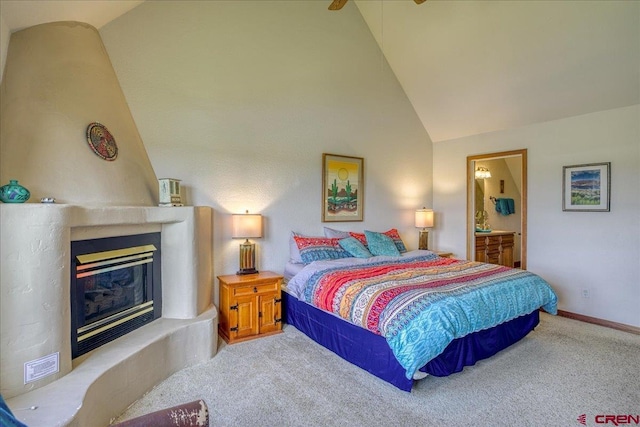 88 W Peregrine Cir Unit 4Unit 1, Pagosa Springs, CO 81147 - bedroom with carpet, a large fireplace, ensuite bath, and high vaulted ceiling