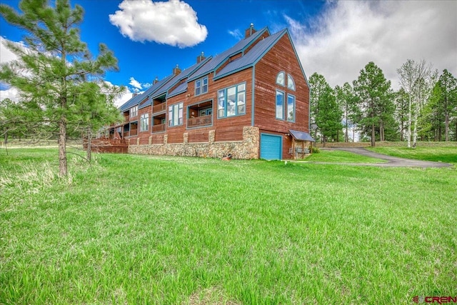 88 W Peregrine Cir Unit 4Unit 1, Pagosa Springs, CO 81147 - view of side of home with an attached garage, a lawn, and a chimney