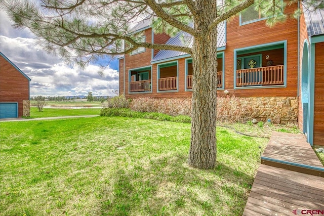 88 W Peregrine Cir Unit 4Unit 1, Pagosa Springs, CO 81147 - view of side of home with a lawn, stone siding, and a water view