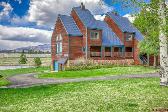 88 W Peregrine Cir Unit 4Unit 1, Pagosa Springs, CO 81147 - view of front of house with an attached garage, a front lawn, driveway, metal roof, and a mountain view