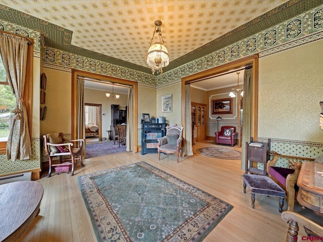 445 4th St, Ouray, CO 81427 - living area with a chandelier, wood-type flooring, and ornamental molding