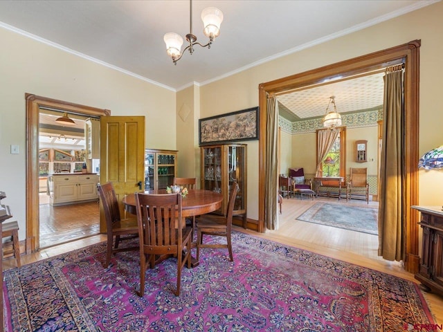 445 4th St, Ouray, CO 81427 - dining space with wood finished floors, a chandelier, and ornamental molding